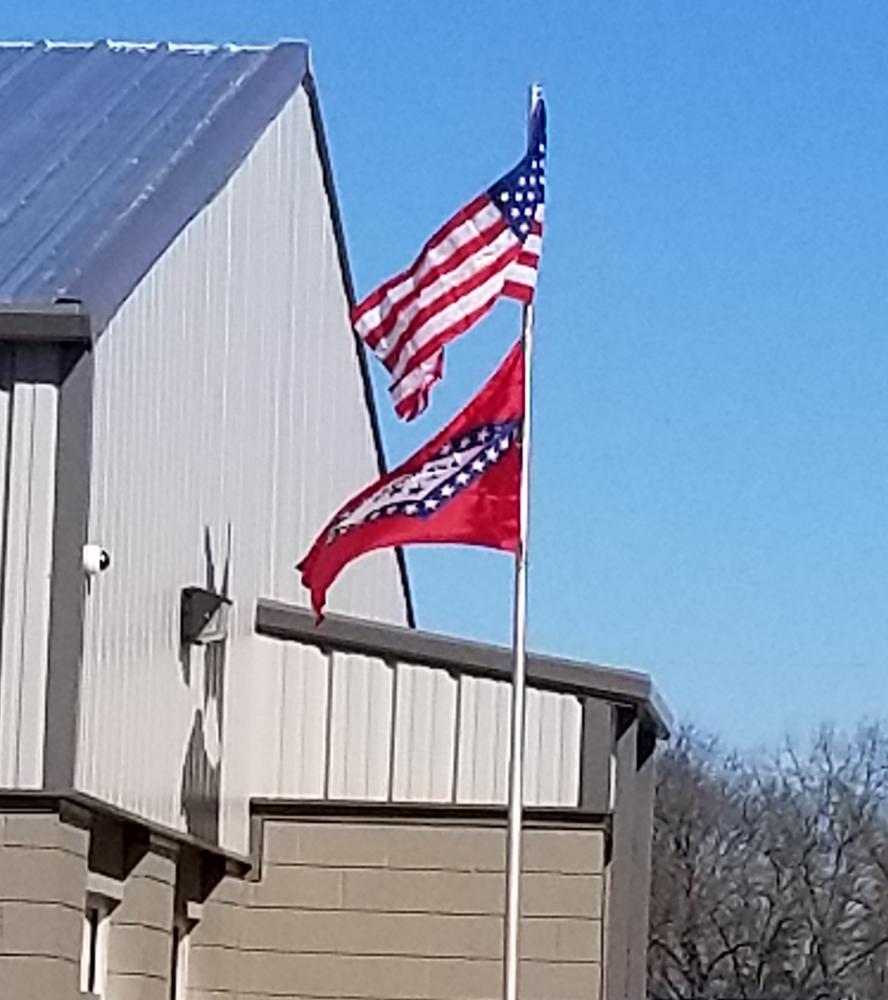 US flag and Arkansas flag flying